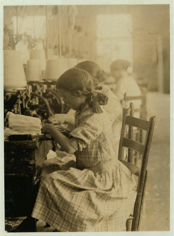 A young girl works a machine at the Walker County Hosiery Mills in LaFayette, Georgia, 1913. Photograph by Lewis Hine.
